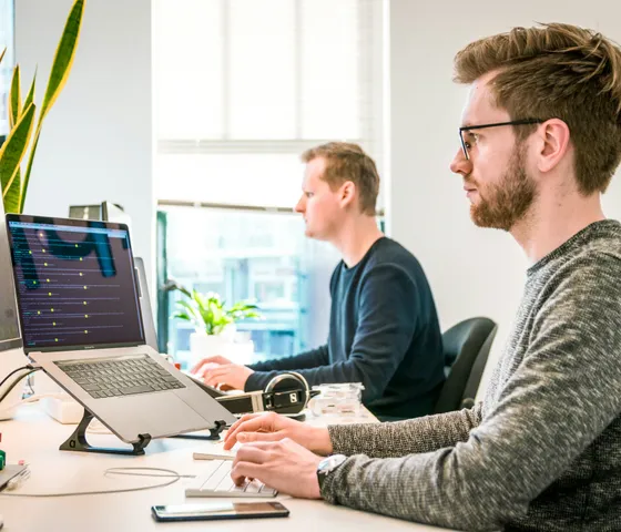 Developers working on cloud, mobile, and software projects in a modern office